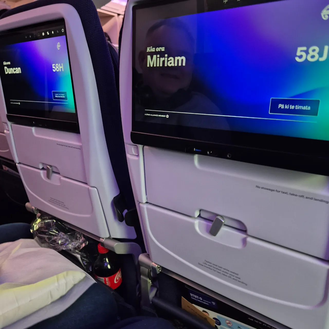 Airline seats showing the names Duncan and Miriam.