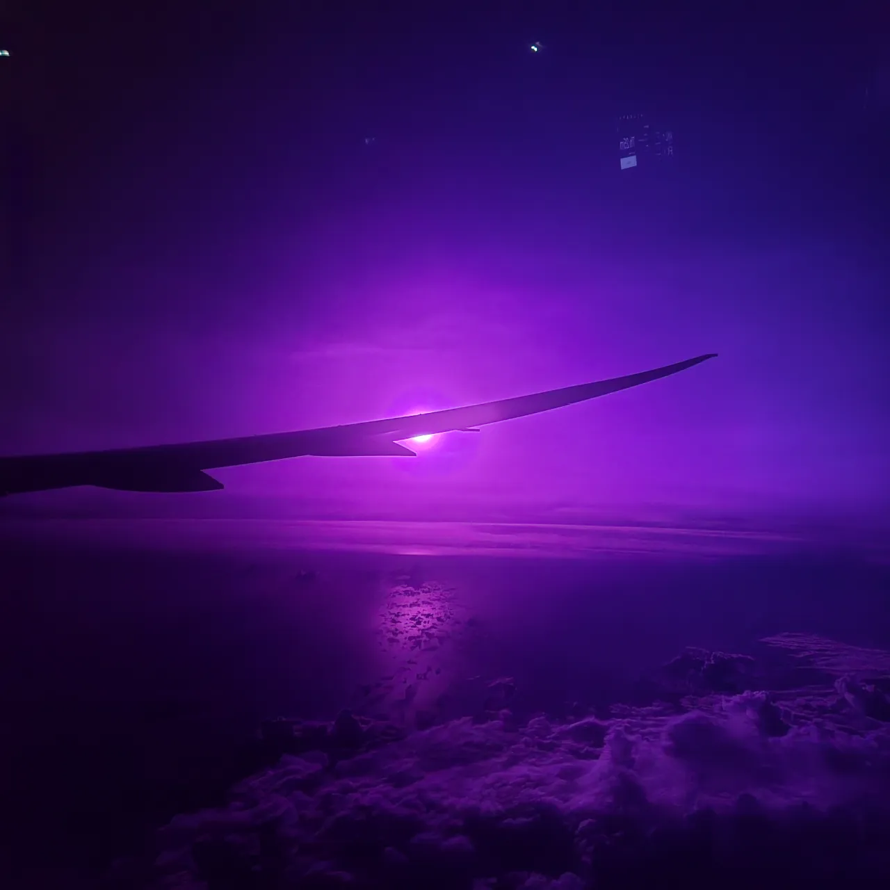 Purple tinted sky seen from an airplane.