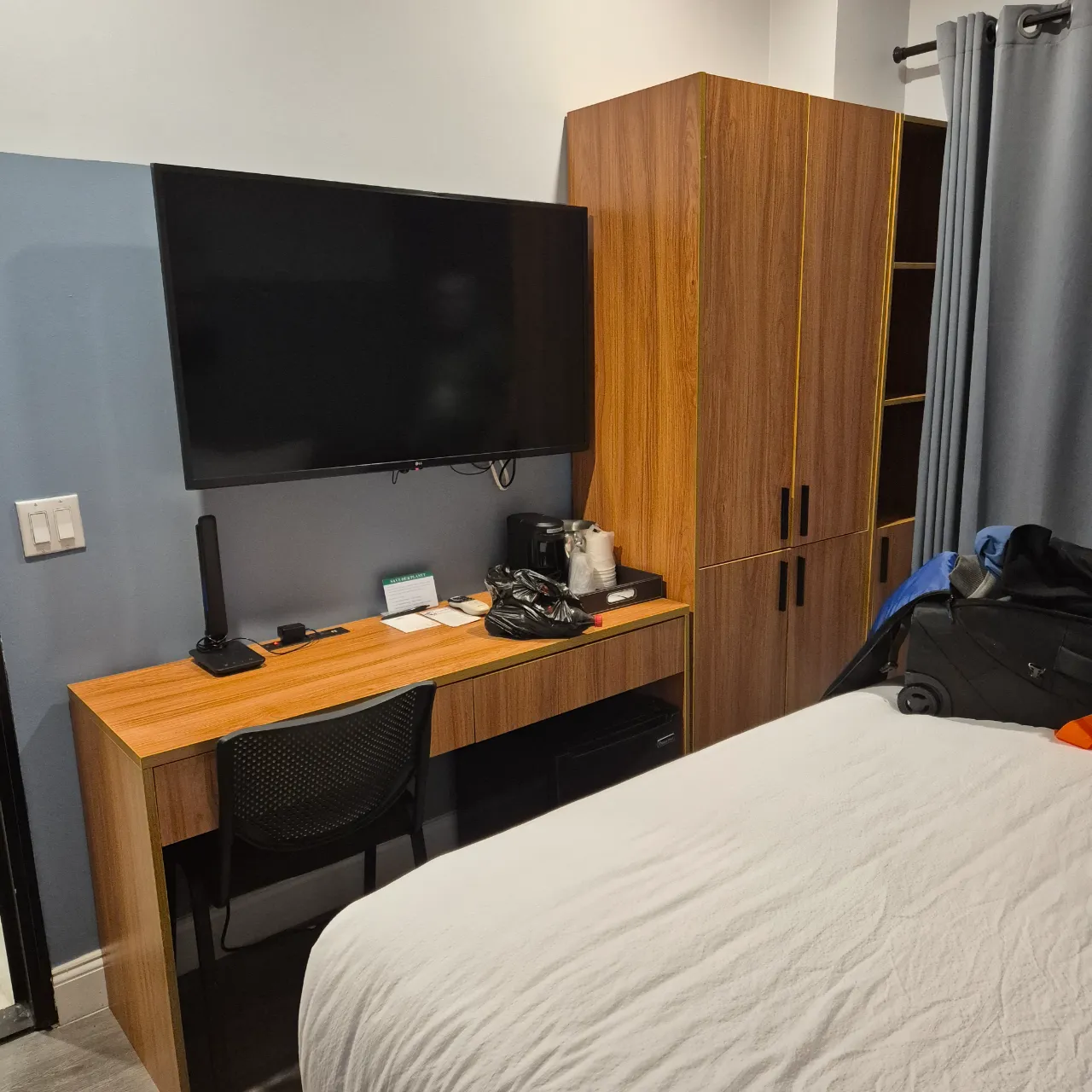 Hotel room showing the entertainment, table, coffee station, and cupboard.